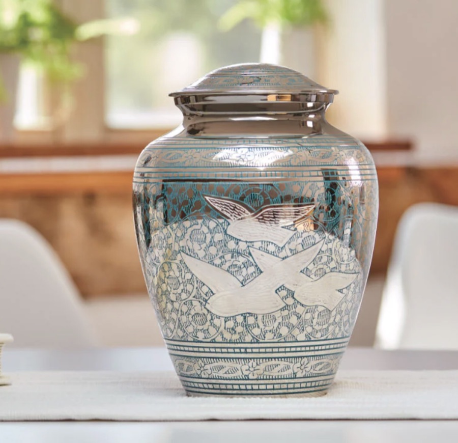Silver and blue engraved urn with a flying doves design